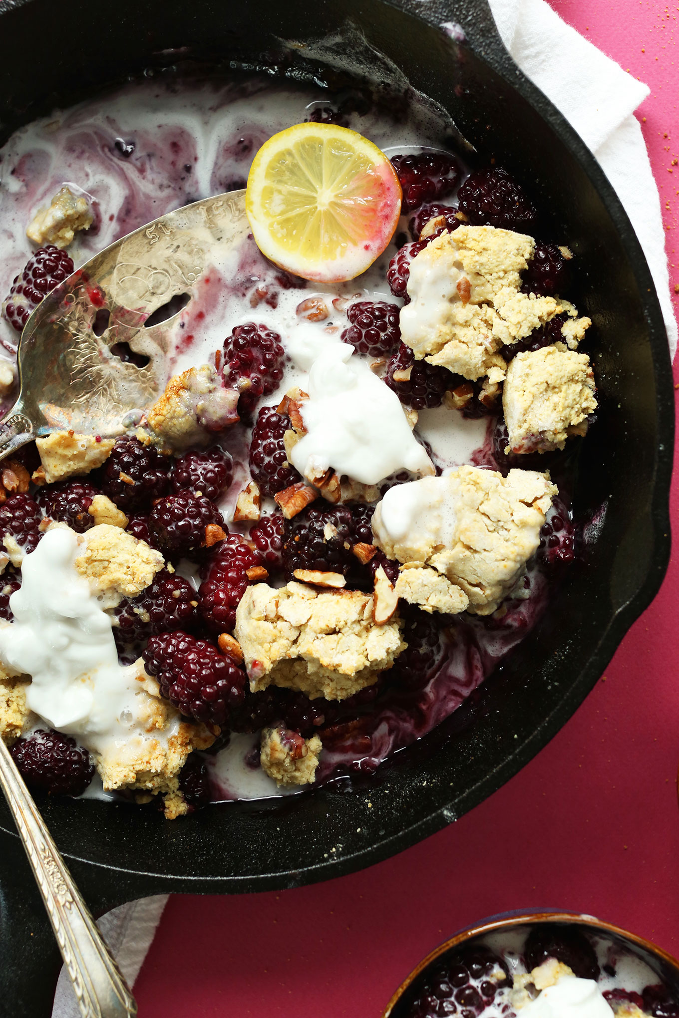 Close up shot of a cast-iron skillet filled with vegan Blackberry Cobbler