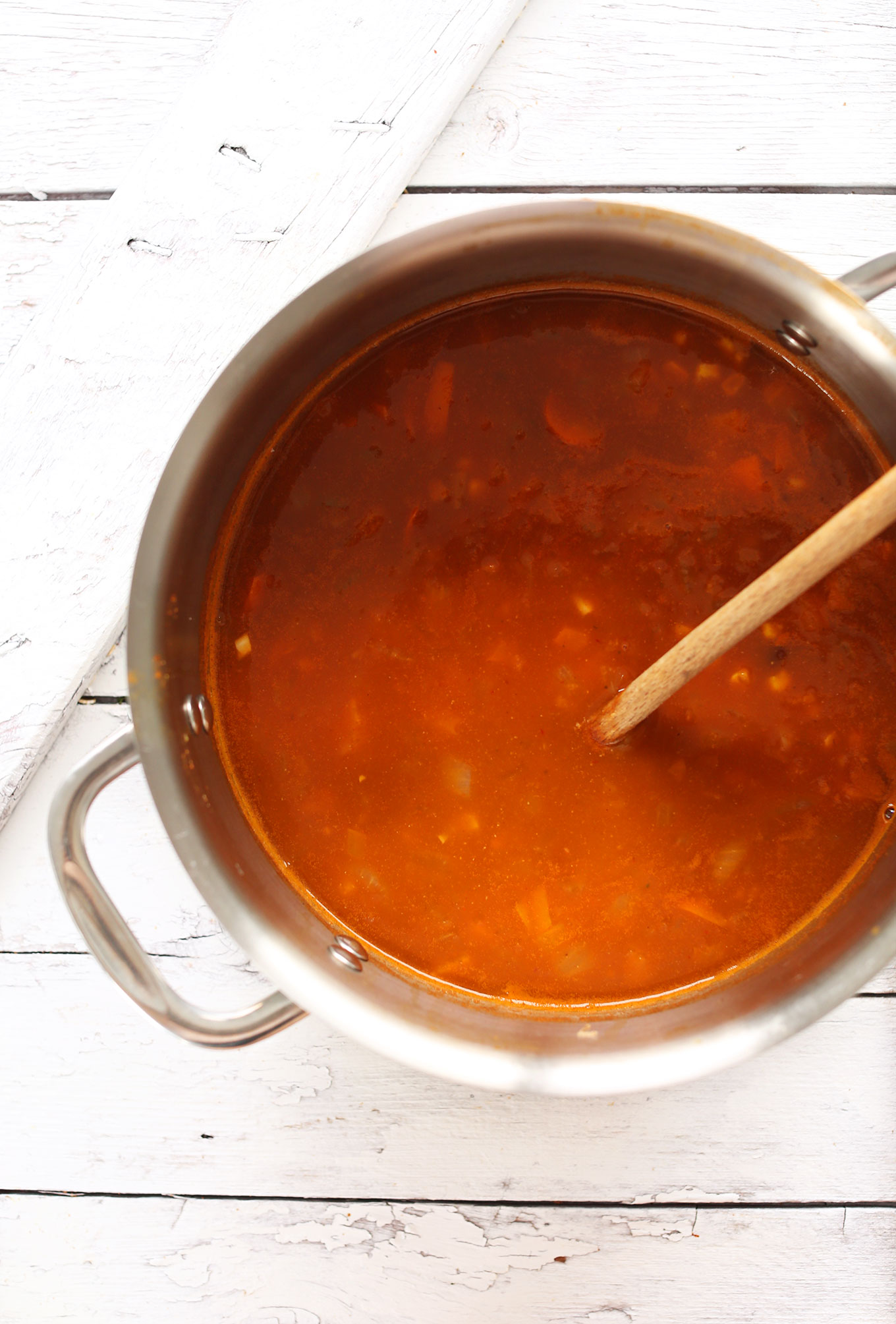 Big soup pot filled with ingredients for making our easy Chipotle Black Bean Tortilla Soup recipe