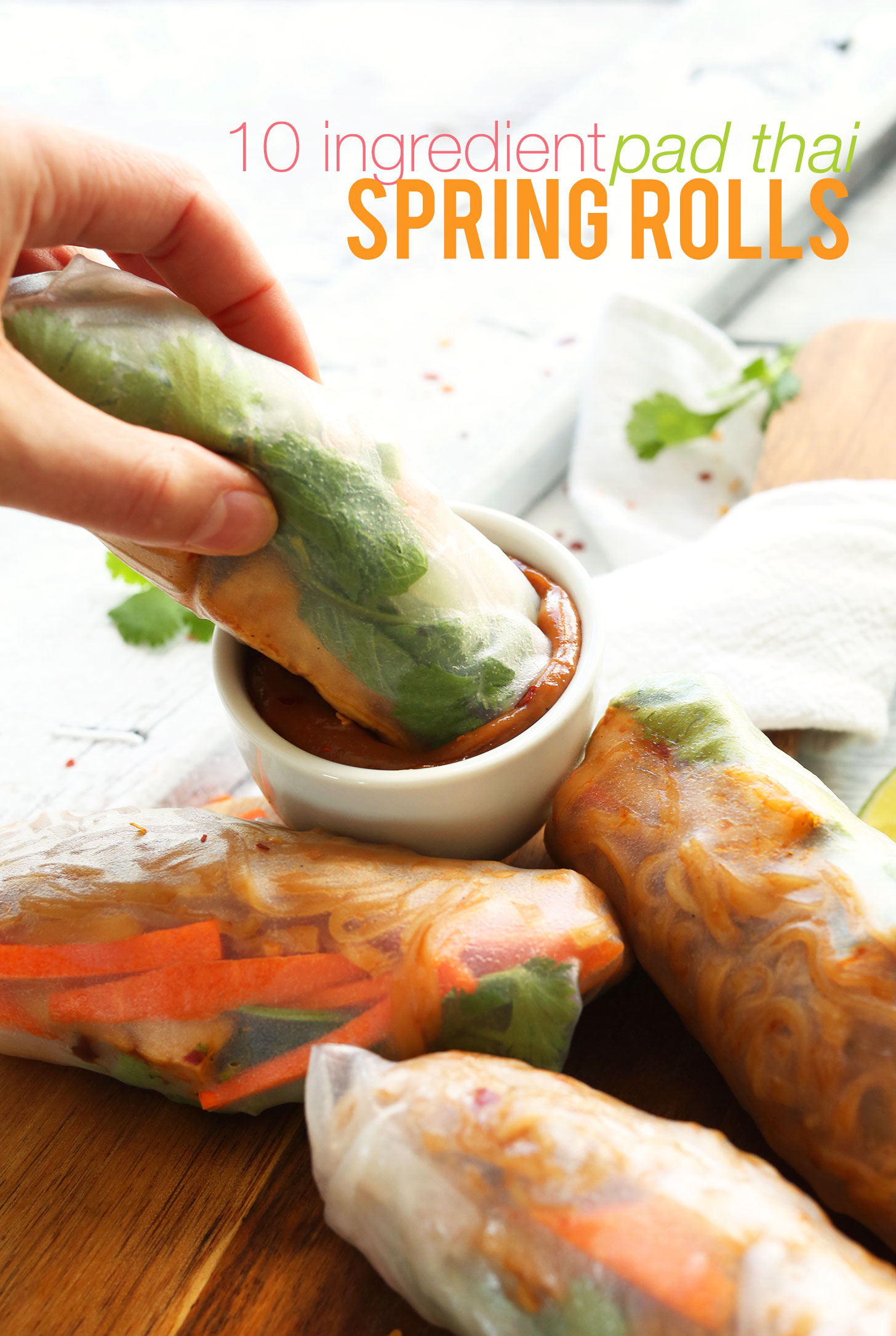 Dipping a homemade Vegan Pad Thai Spring Roll into peanut sauce