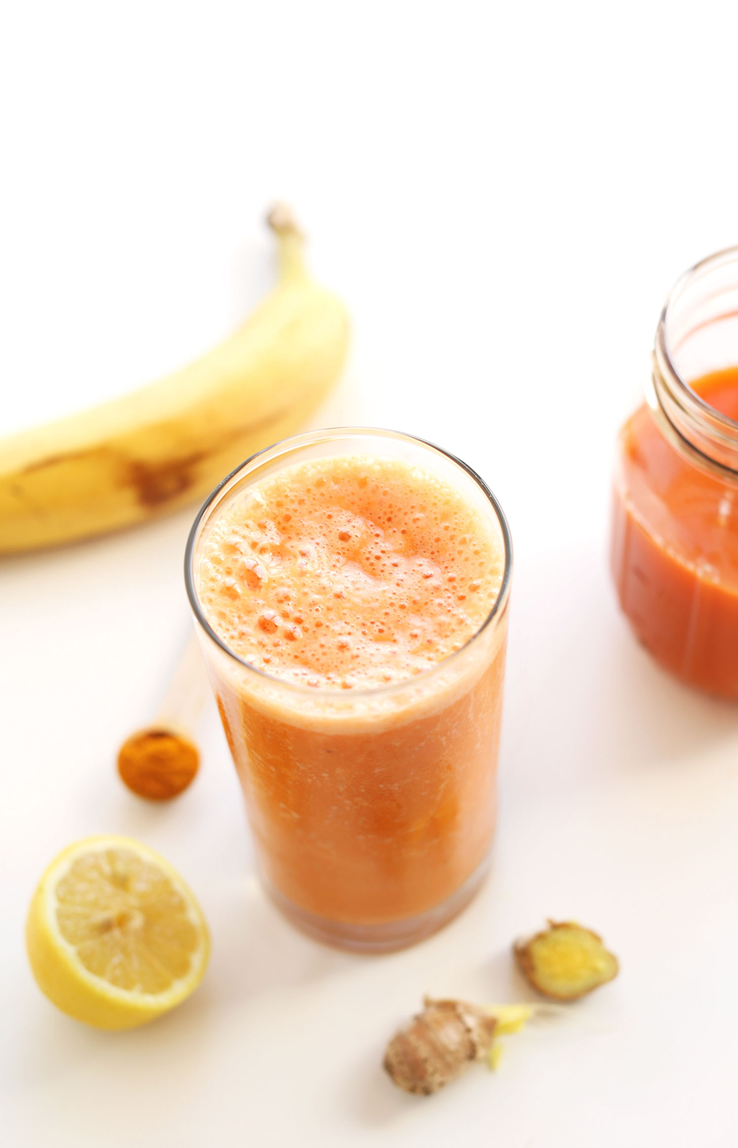 Glass of our refreshing and delicious vegan Carrot Ginger Turmeric Smoothie