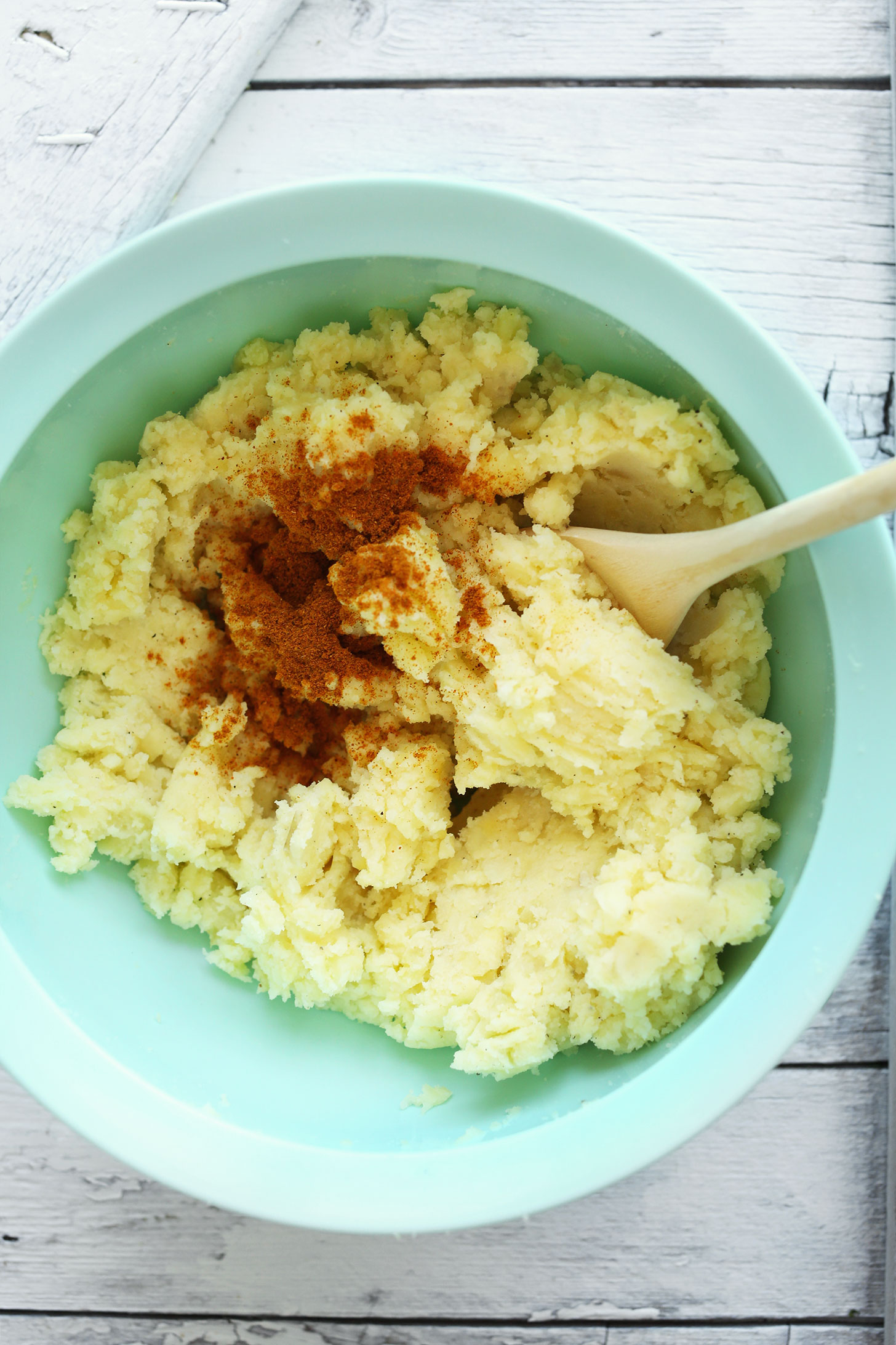 Stirring potatoes and spices for gluten-free vegan Curry Spiced Samosa Potato Cakes