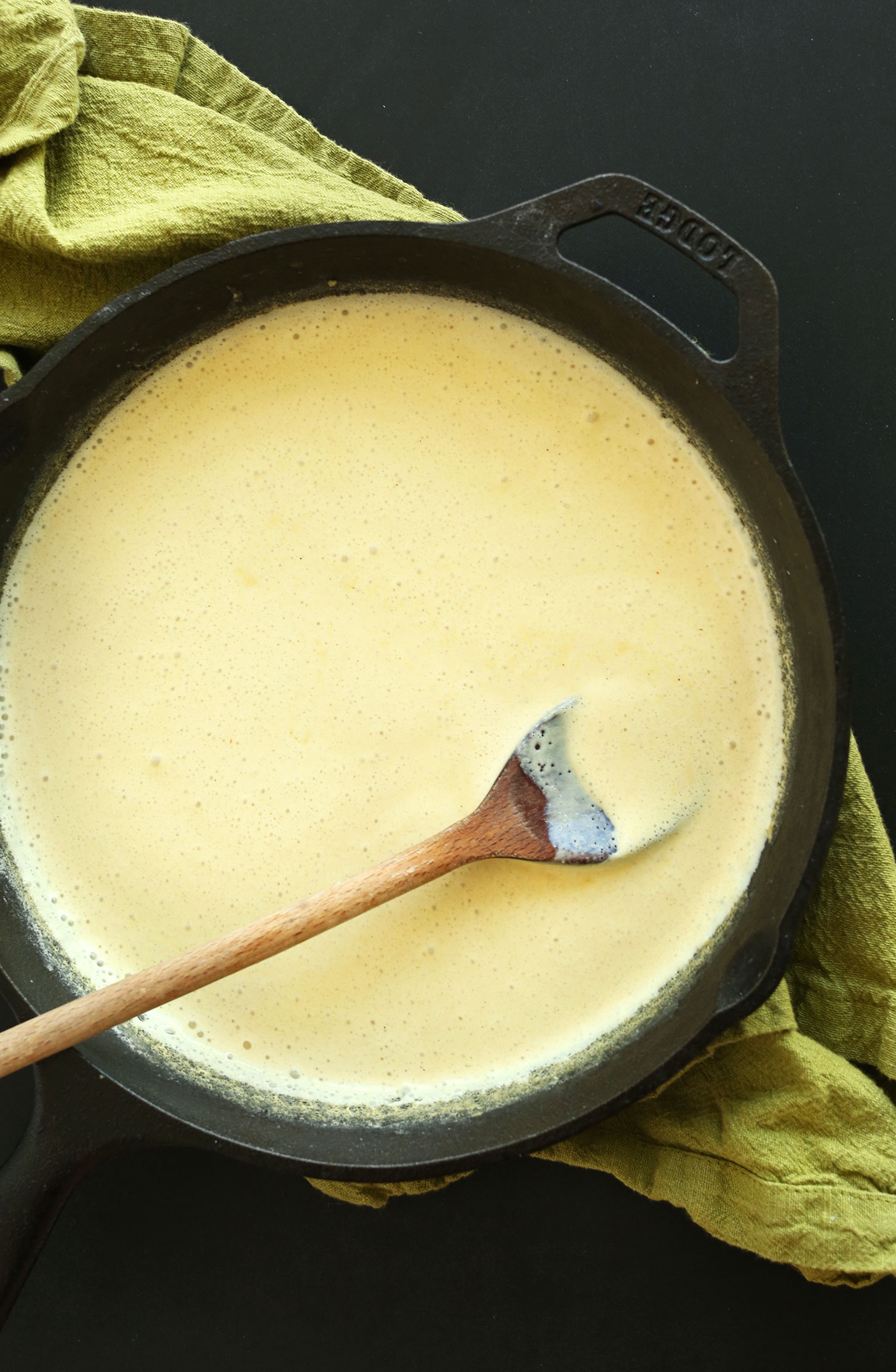 Cast-iron skillet filled with easy homemade Vegan Alfredo sauce