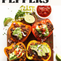 Cutting board with salsa, lime, and quinoa stuffed peppers made with Mexican-inspired seasonings