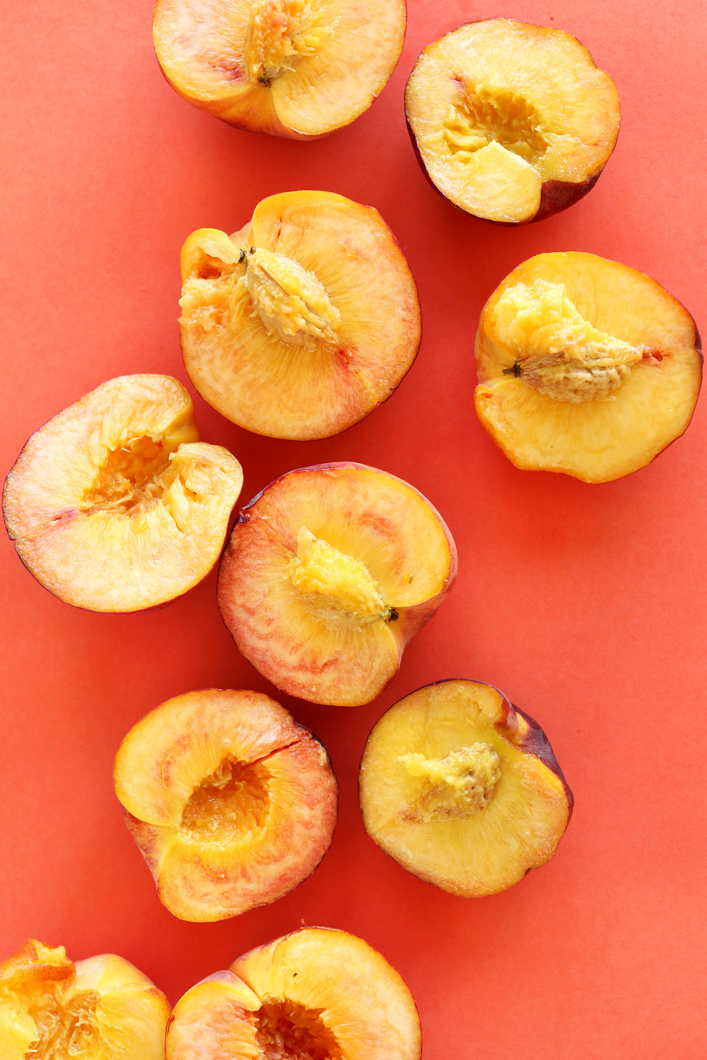 Halved fresh peaches for making gluten-free vegan crisp