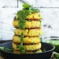 Stack of Indian Potato Cakes with Green Chutney dripping down the side