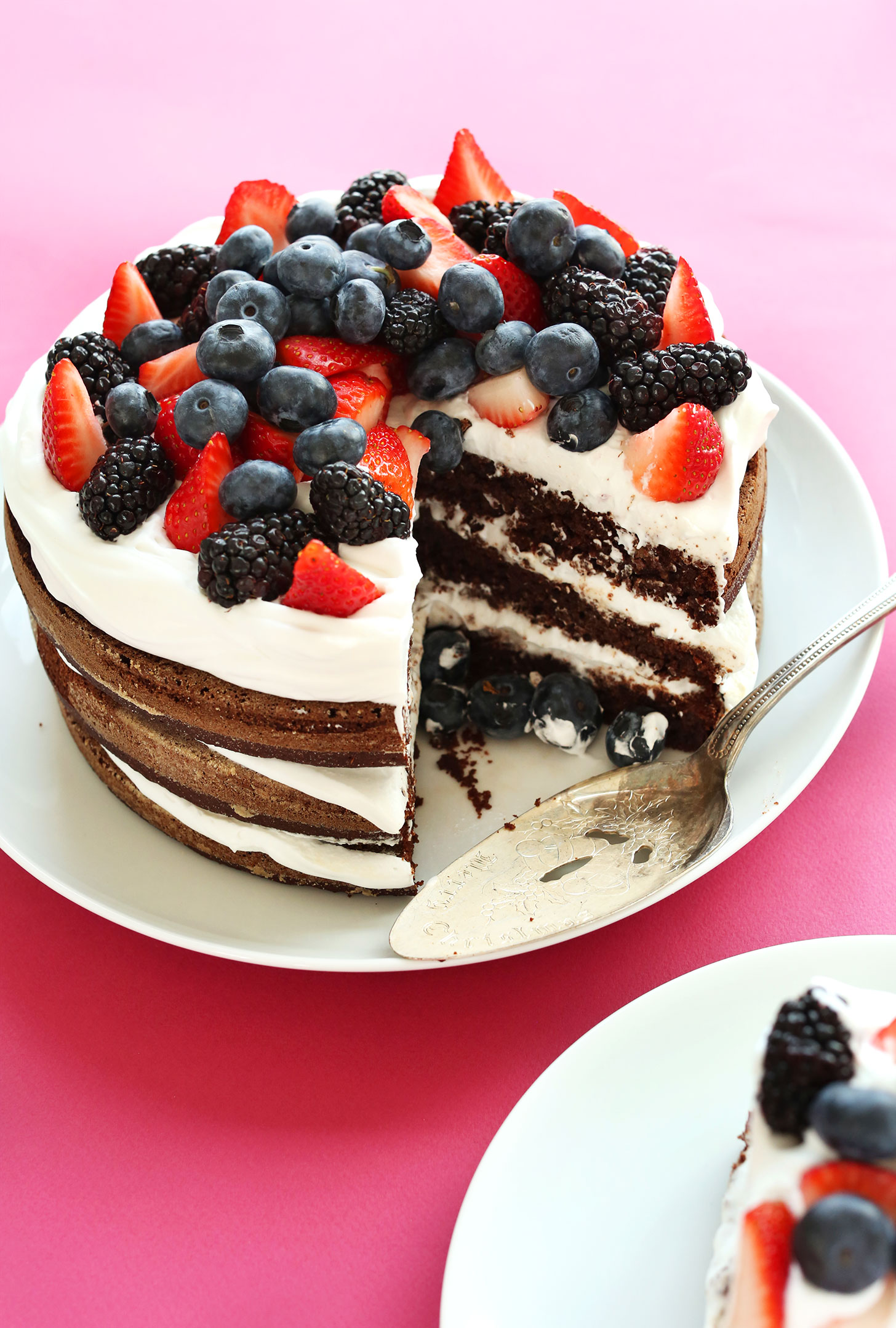 Plate of our 1-bowl gluten-free vegan Chocolate Birthday Cake with a slice removed