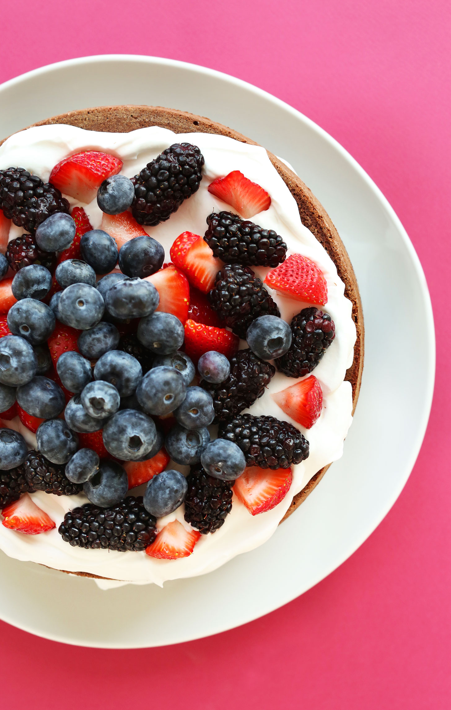 Plate of gluten-free vegan Chocolate Cake with Coconut Whip and Berries