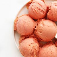 Scoops of Mango Raspberry Coconut Sorbet for a refreshing vegan summer dessert
