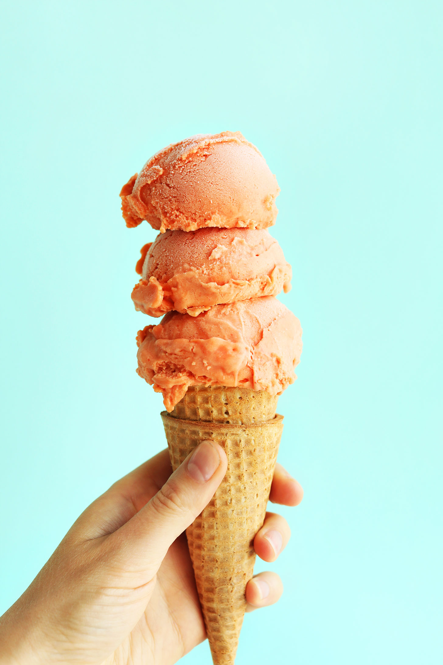 Scoops of our Creamy Mango Raspberry Coconut Sorbet for a delicious summer vegan dessert