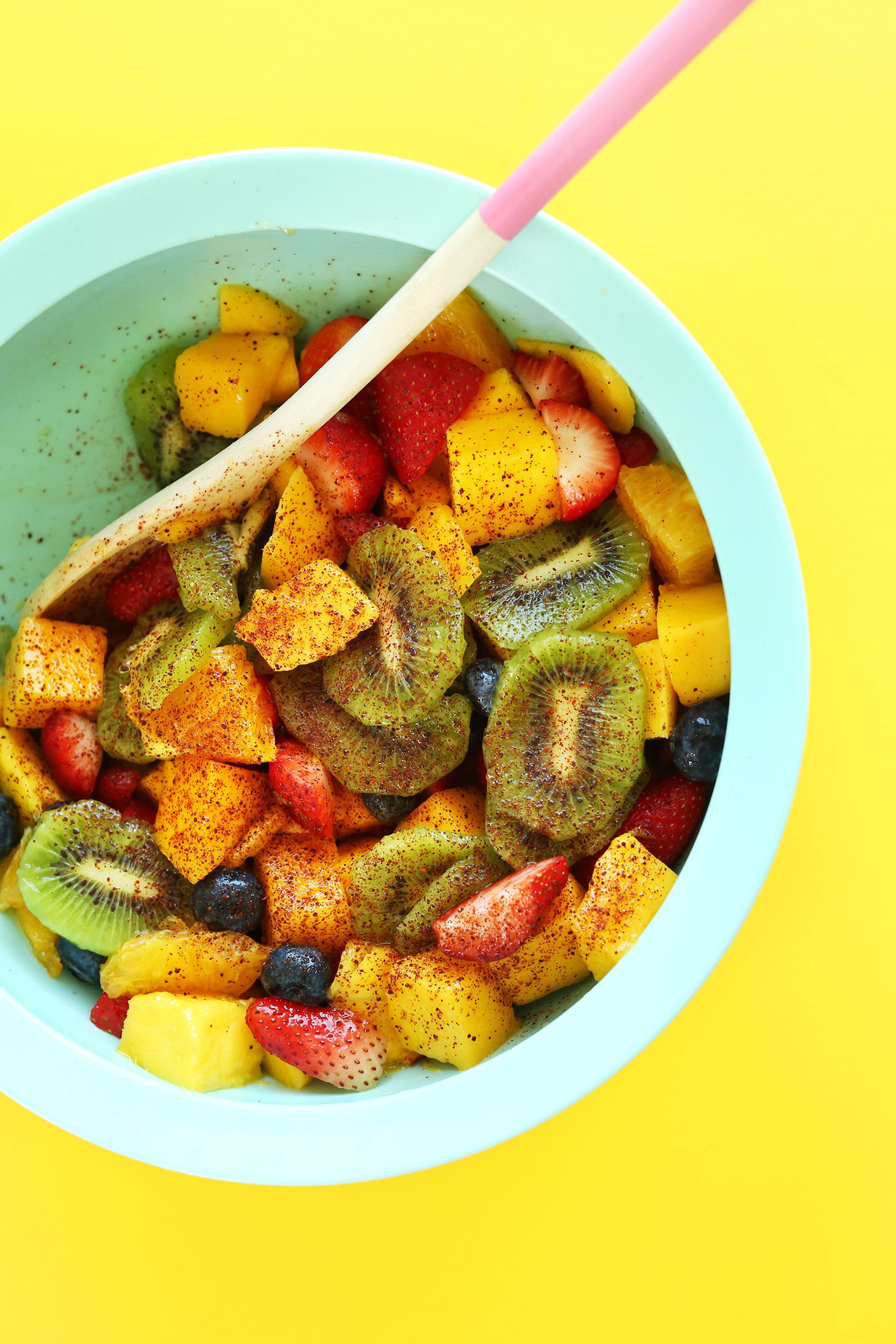 A bowl of our Spicy Fruit Salad sprinkled with chili powder for a kick of heat