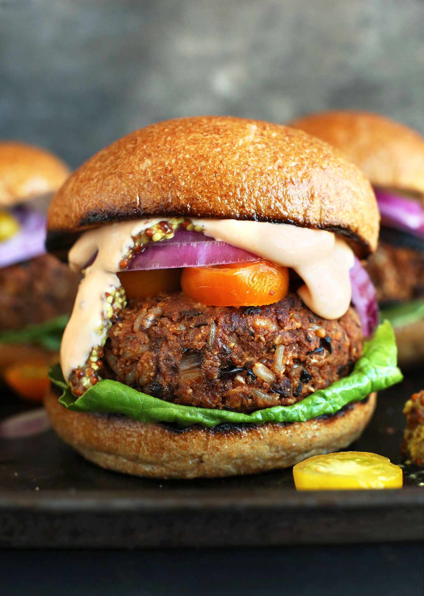 An amazing grillable Veggie Burger patty on a bun with lettuce, tomato, onion and sauce