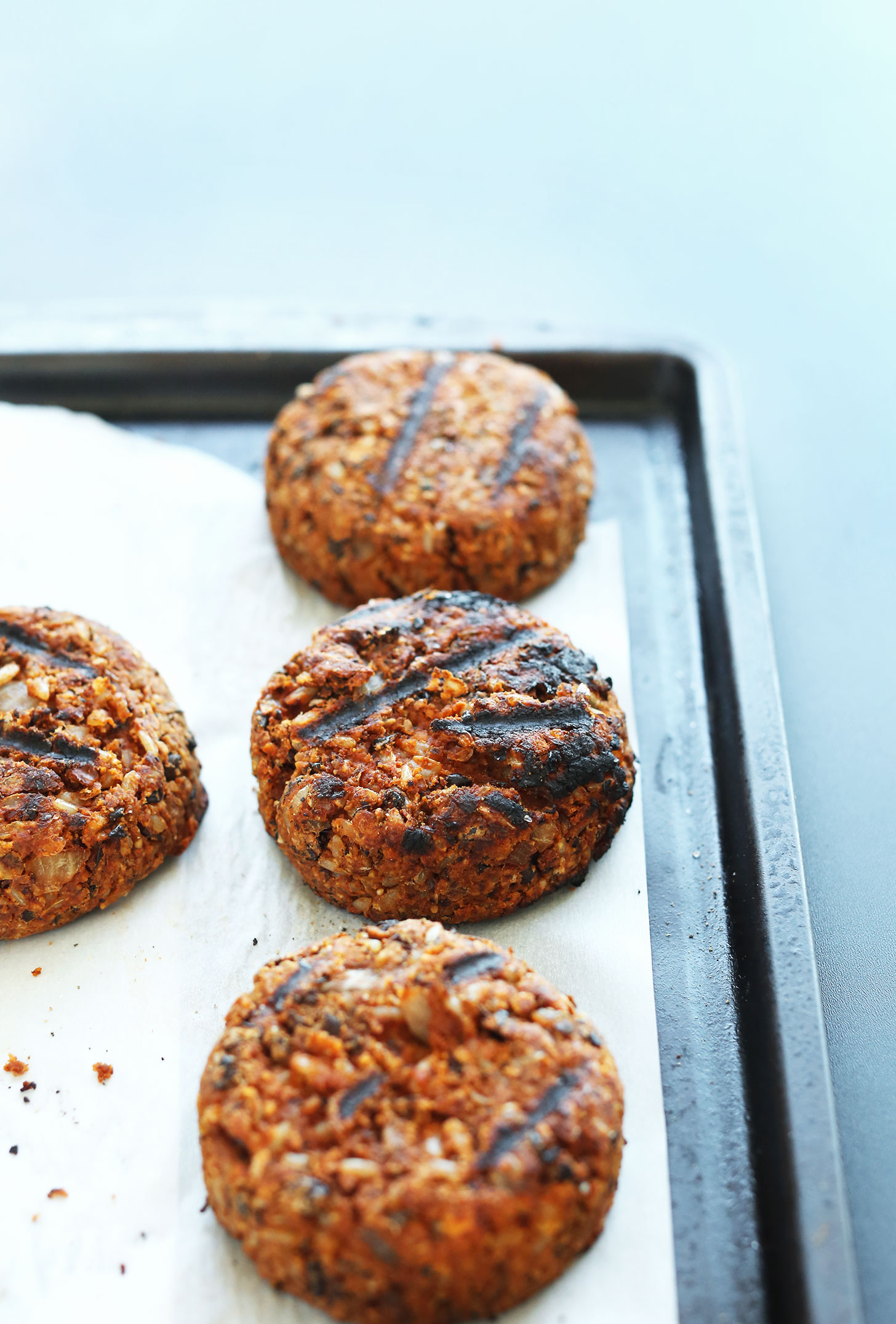 Parchment-lined baking sheet with freshly grilled homemade Veggie Burgers