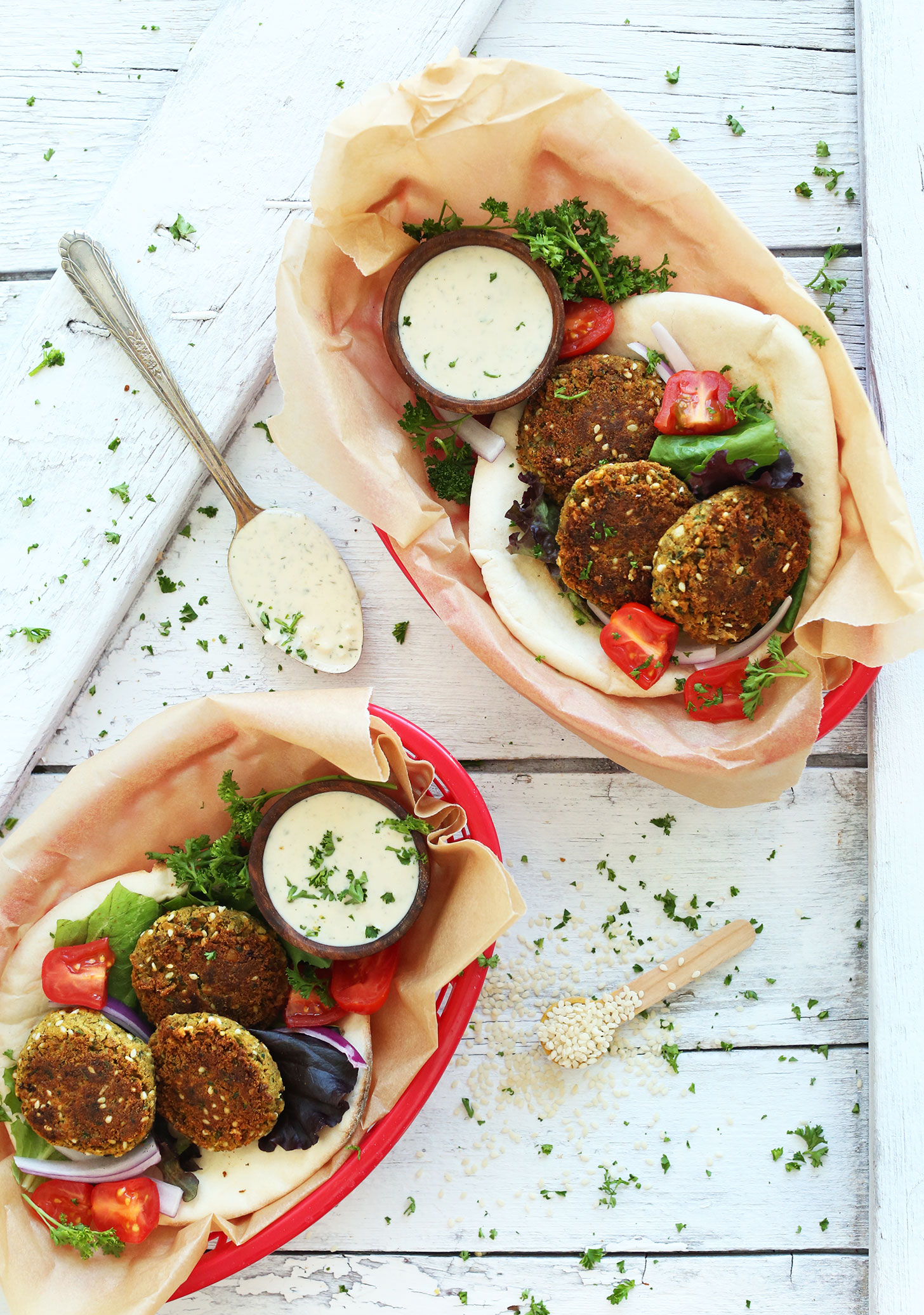 Serving containers filled with pita bread topped with homemade Simple Vegan Falafel 