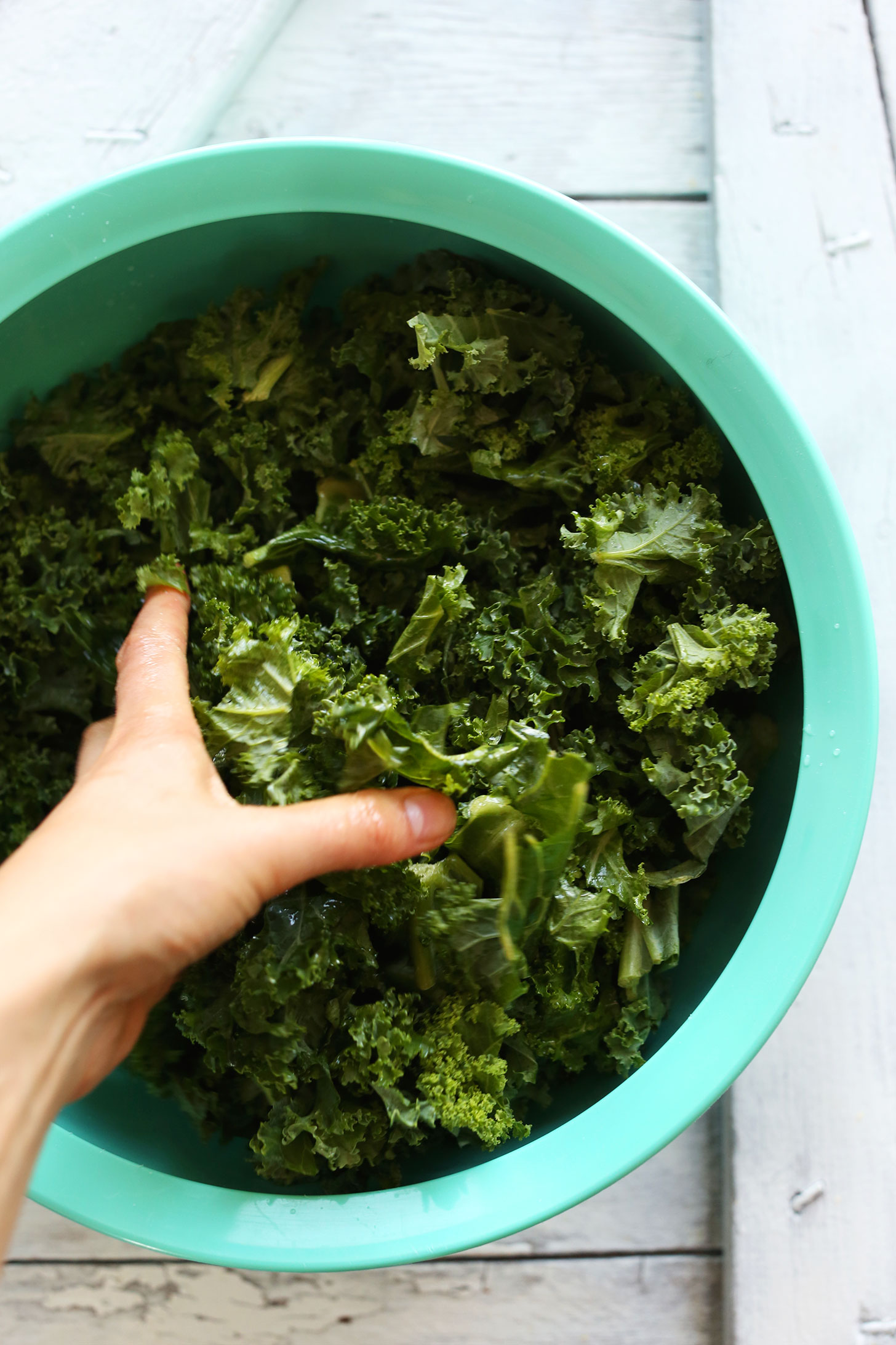 Massaging kale for making a healthy and refreshing vegan salad