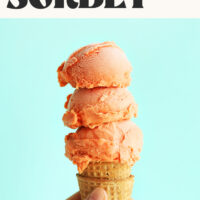Ice cream cone with three scoops of homemade raspberry coconut mango sorbet and text that says just 6 ingredients