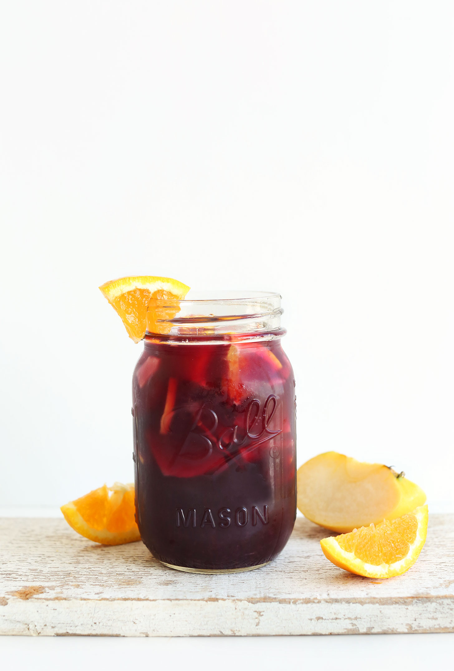 Jar of our refreshing homemade Traditional Red Sangria with an orange slice on the rim