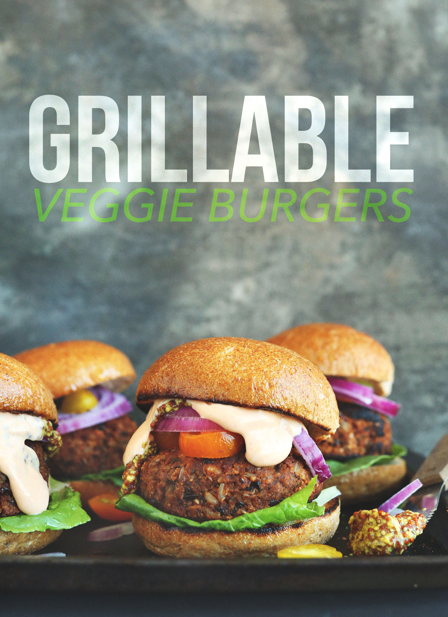 Baking sheet with several grilled Veggie Burgers with toppings and buns