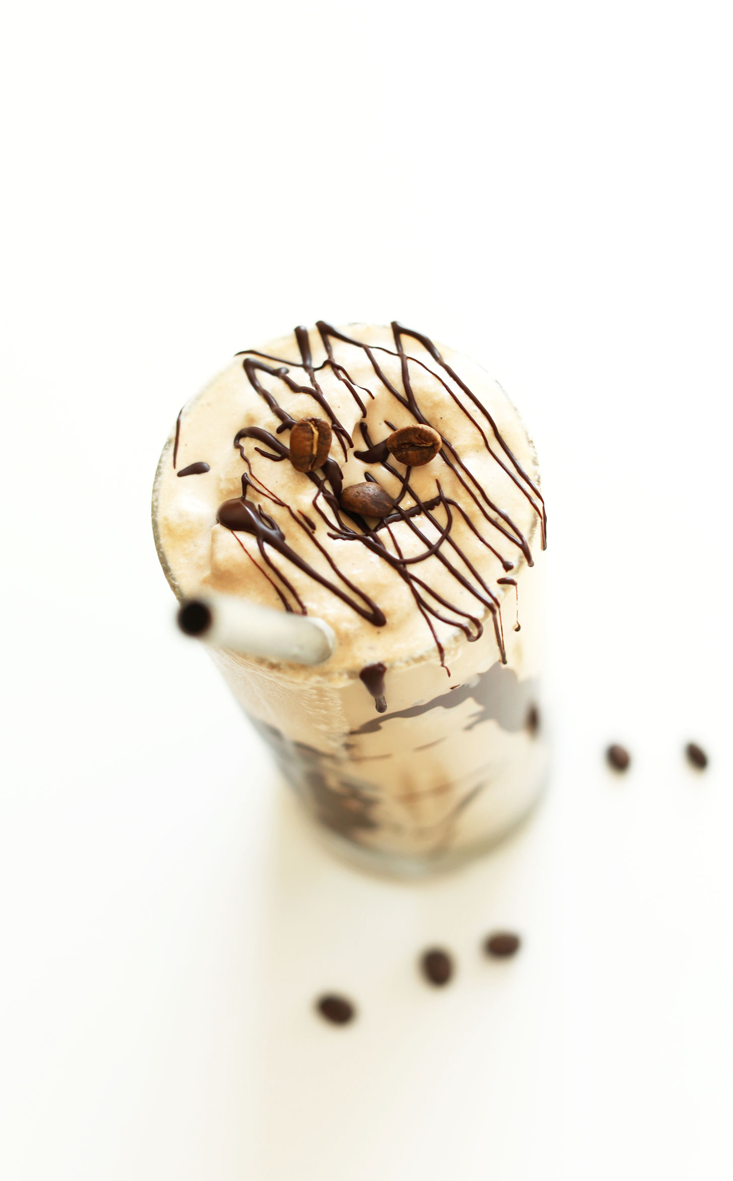 Glass of our Vegan Mocha Shake drizzled with chocolate sauce
