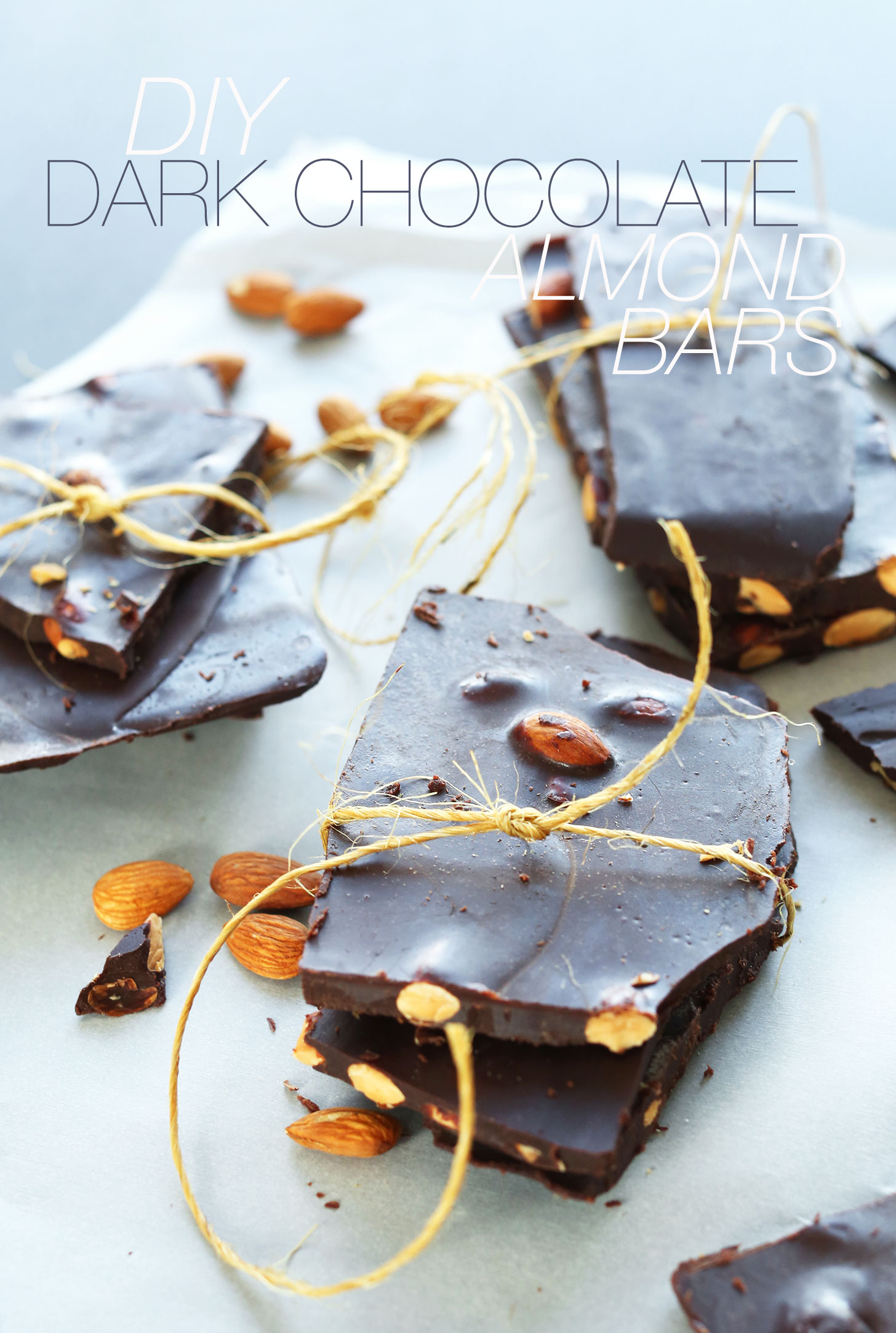 Stacks of homemade vegan Dark Chocolate Almond Bars wrapped with twine
