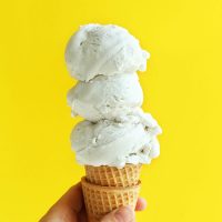 Triple scooped Vanilla Bean Coconut Ice Cream on a stack of sugar cones