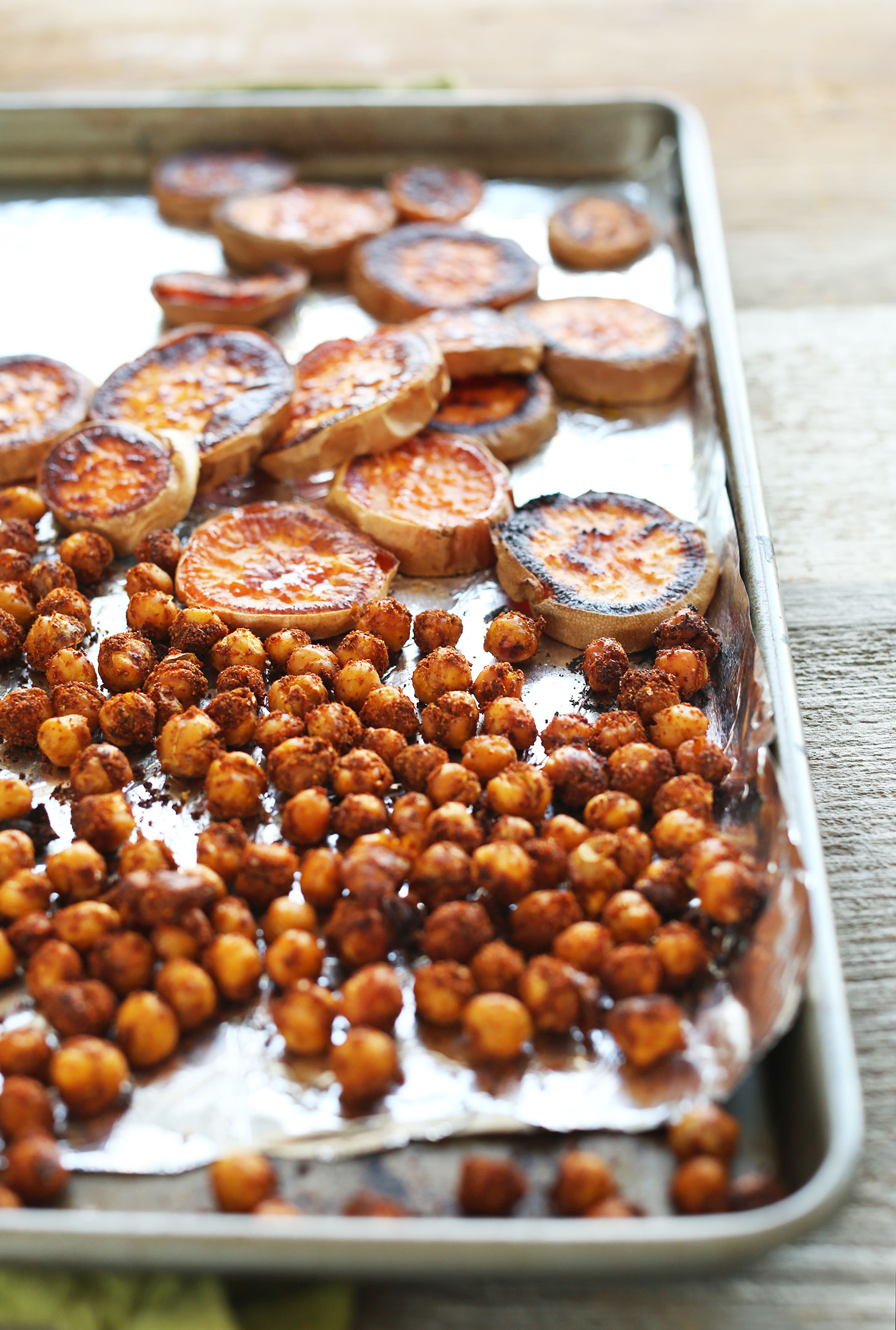 Foil-lined baking sheet with roasted sweet potatoes and crispy chickpeas