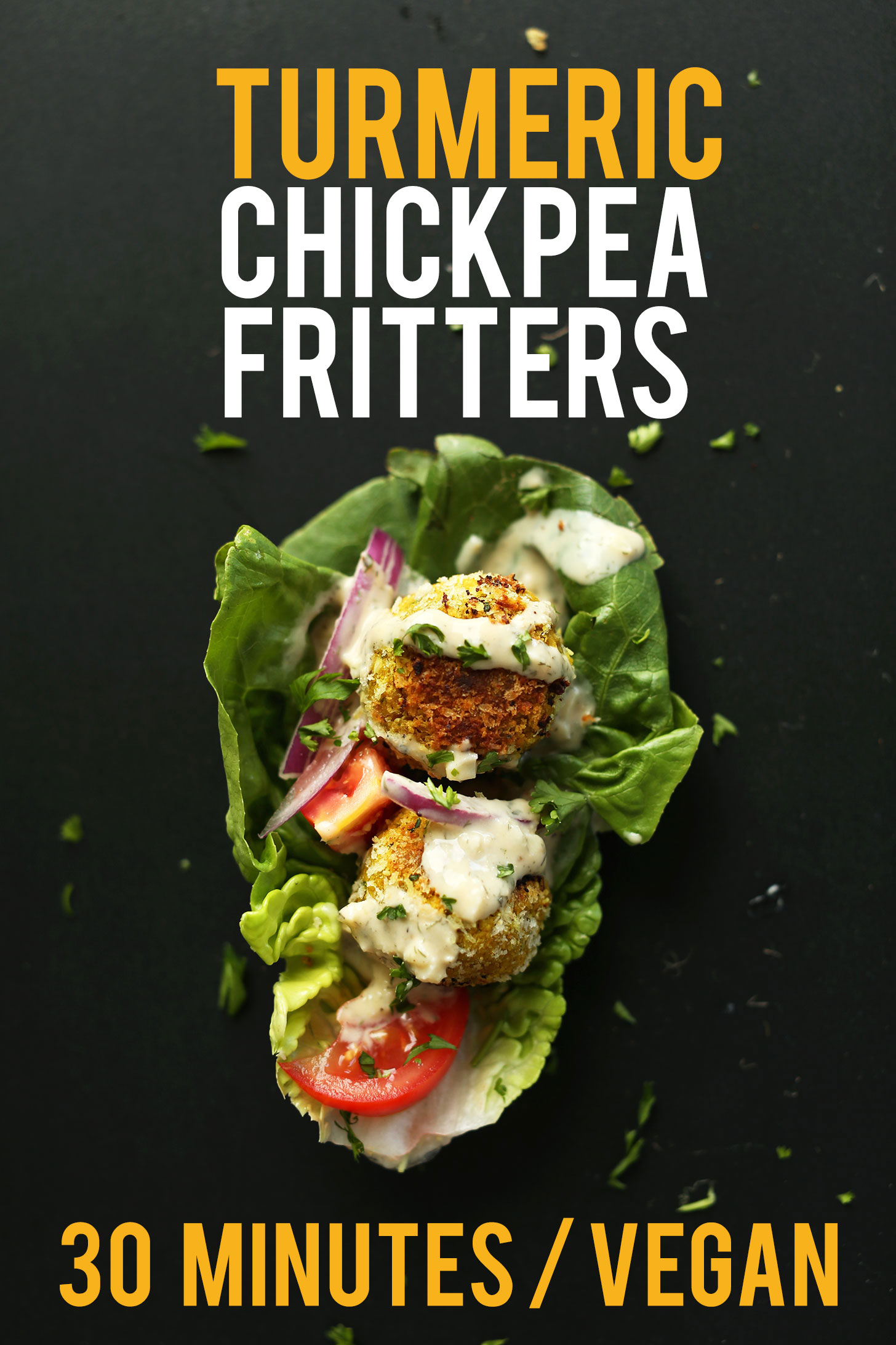 Lettuce leaf topped with Turmeric Chickpea Fritters, tomatoes, red onion, and sauce