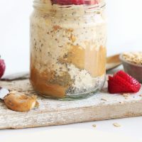 Jar of Peanut Butter Overnight Oats topped with sliced strawberries and banana