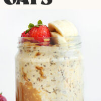 Jar of Peanut Butter Overnight Oats topped with strawberries and banana with text above it that says just 5 ingredients
