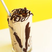 Glass of a vegan milkshake topped with our recipe for How to Make Magic Shell