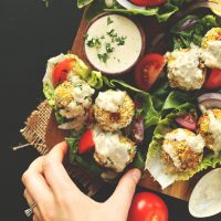 Grabbing Turmeric Chickpea Fritters wrapped in a lettuce leaf
