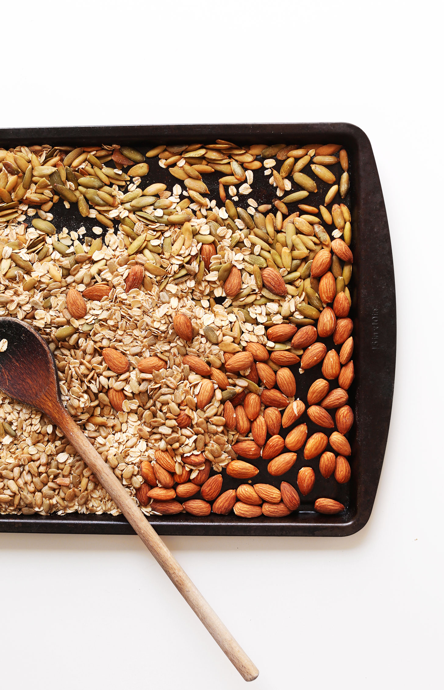 Baking sheet with nuts and seeds for making our delicious homemade muesli recipe