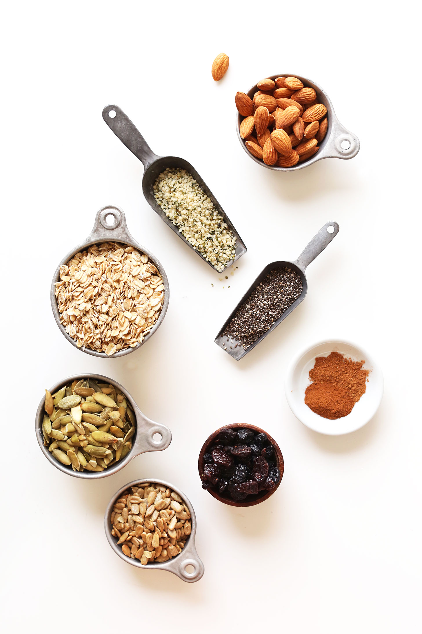 Hemp seeds, chia seeds, almonds, oats, pumpkin seeds, sunflower seeds, dried fruit, and spices for making homemade muesli