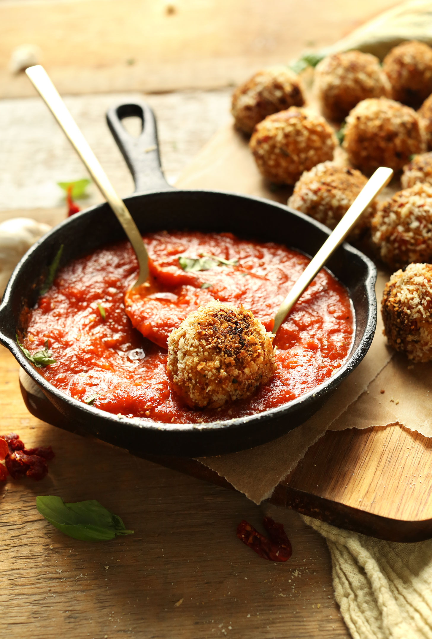 Dipping Vegan Arancini into tomato basil marinara sauce