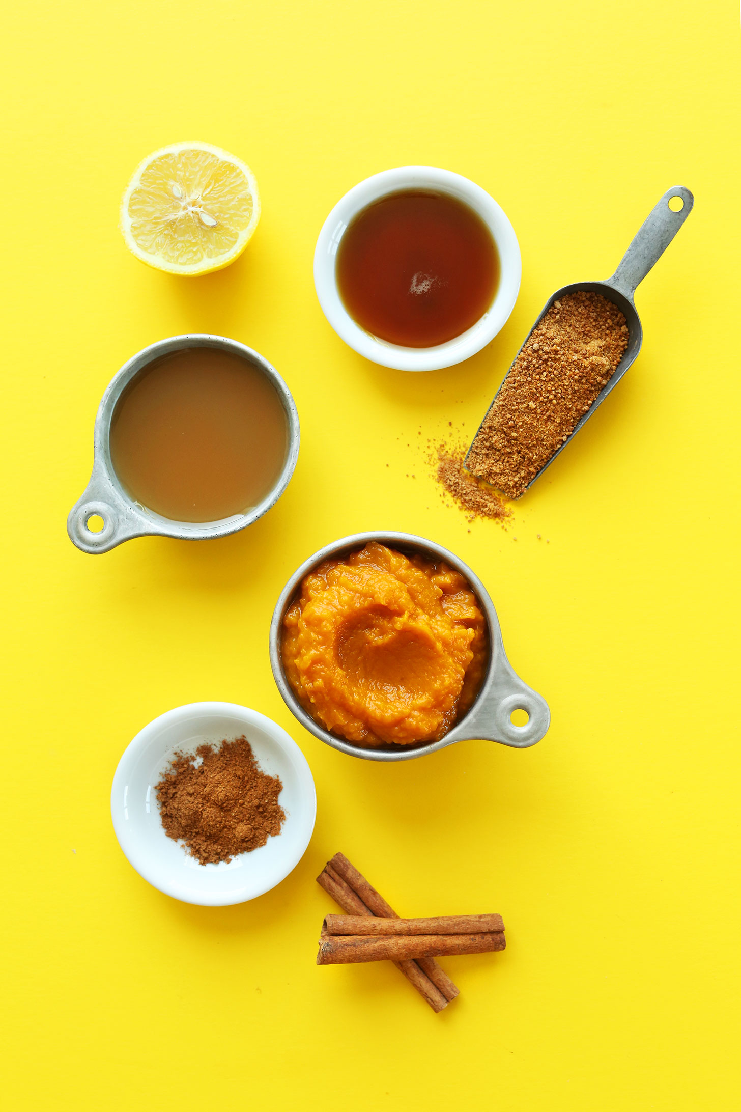 Lemon, maple syrup, apple juice, cinnamon, coconut sugar, and pumpkin puree for making homemade Pumpkin Butter