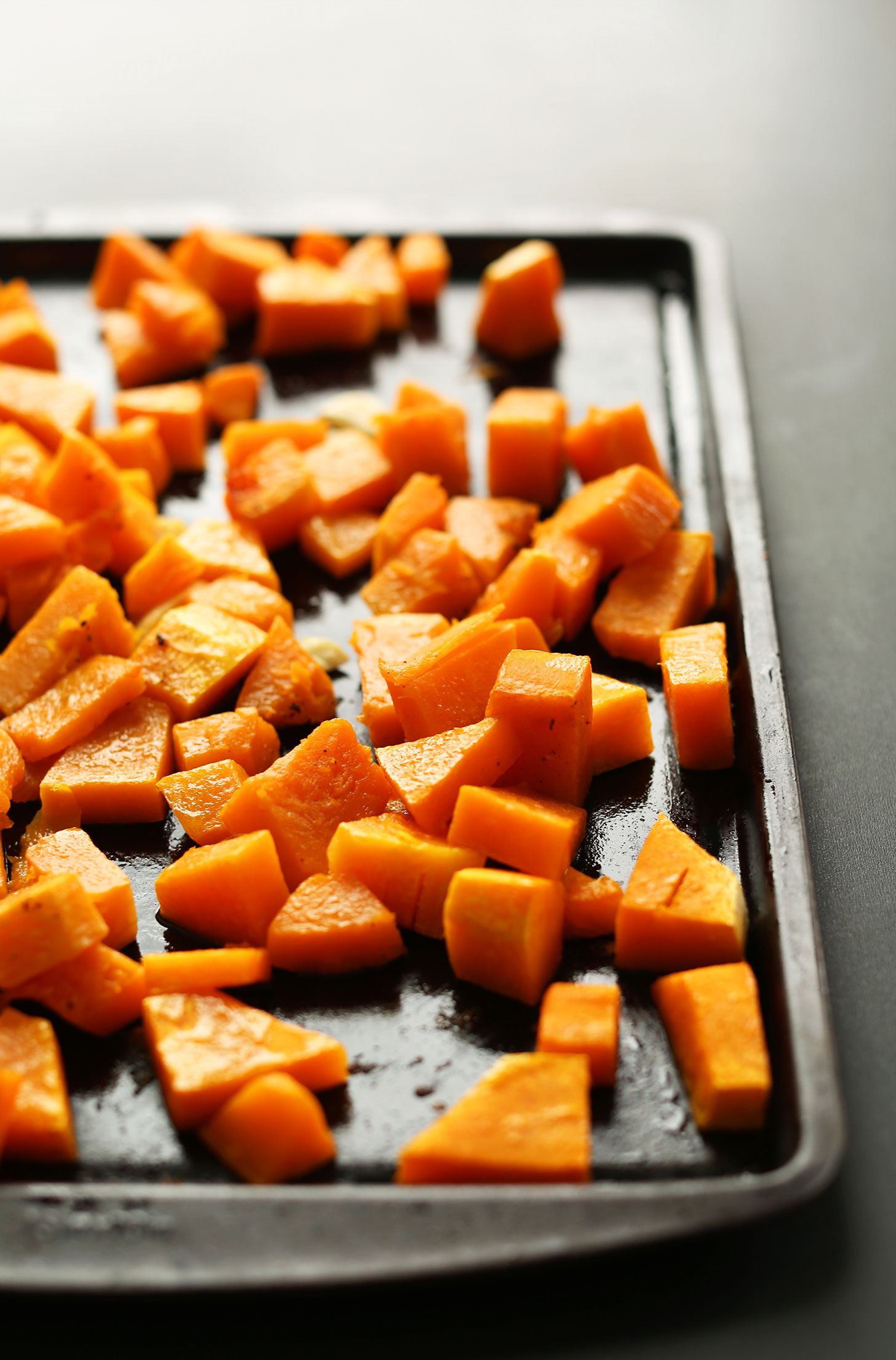 Baking sheet filled with cubes of perfectly roasted butternut squash