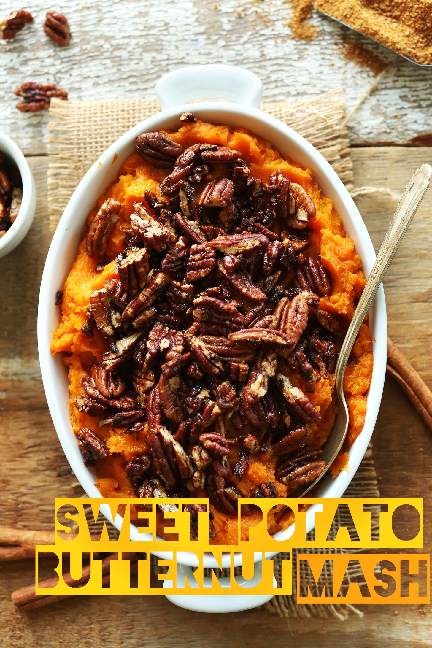 Ceramic baking dish filled with our delicious gluten-free vegan side dish of Butternut Squash Sweet Potato Mash with Maple Cinnamon Pecans