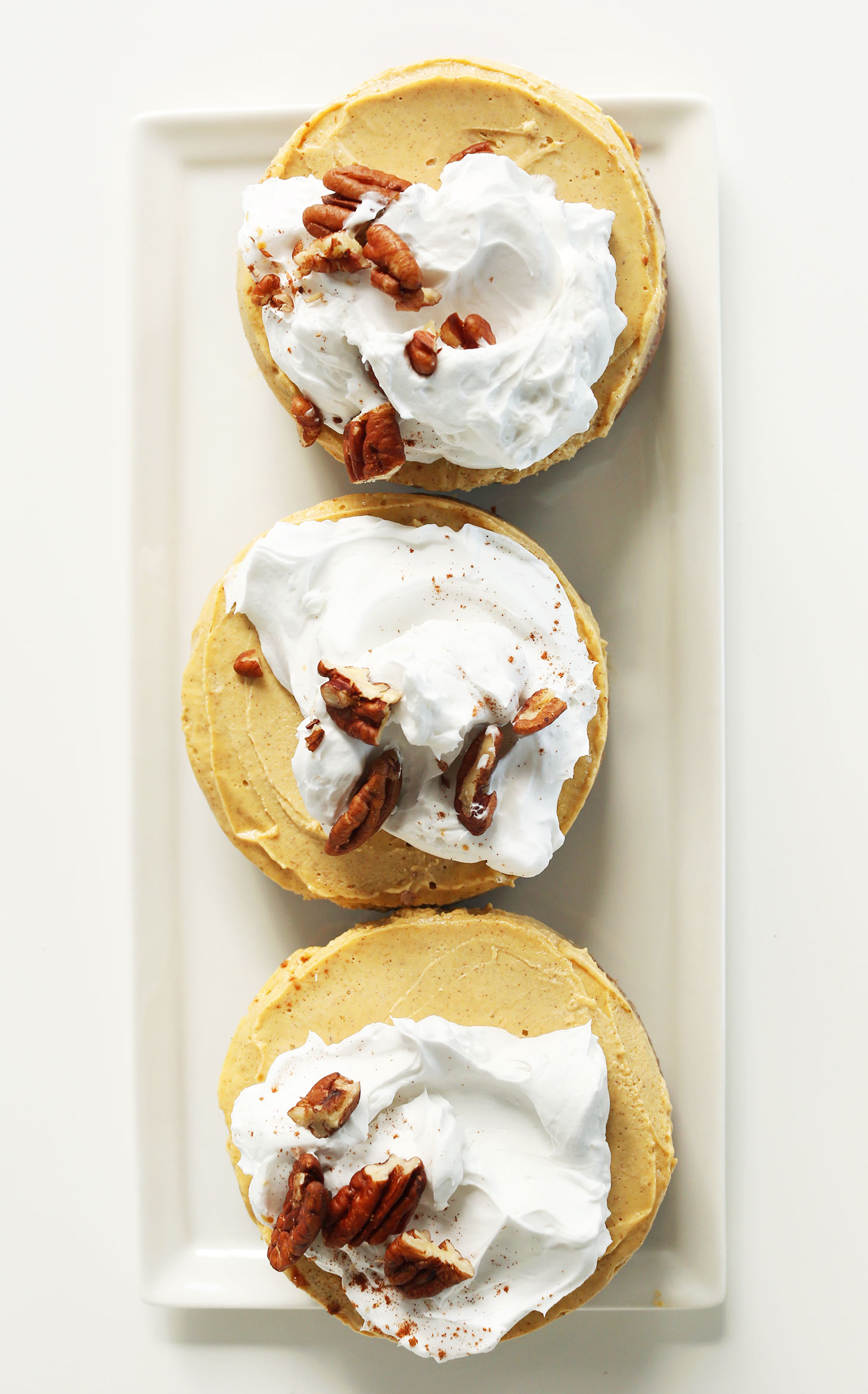 Platter with three mini Vegan Pumpkin Cheesecakes for a delicious dessert