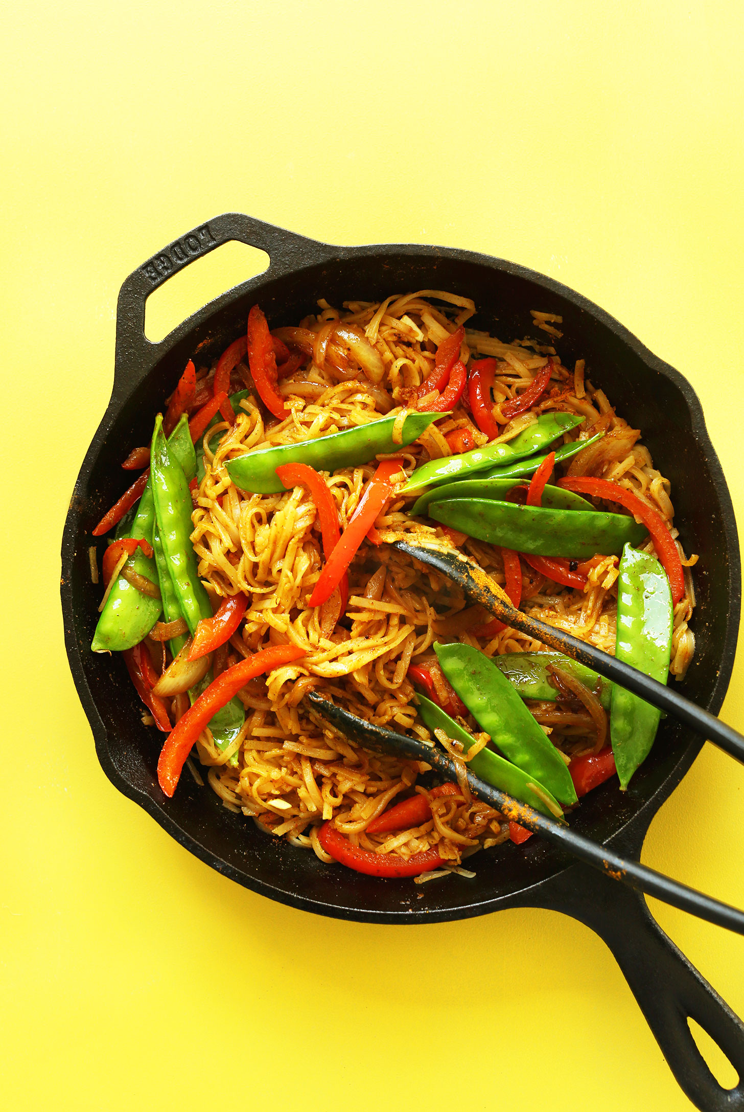 Cast-iron skillet filled with Singapore Noodles for a healthy easy vegan dinner