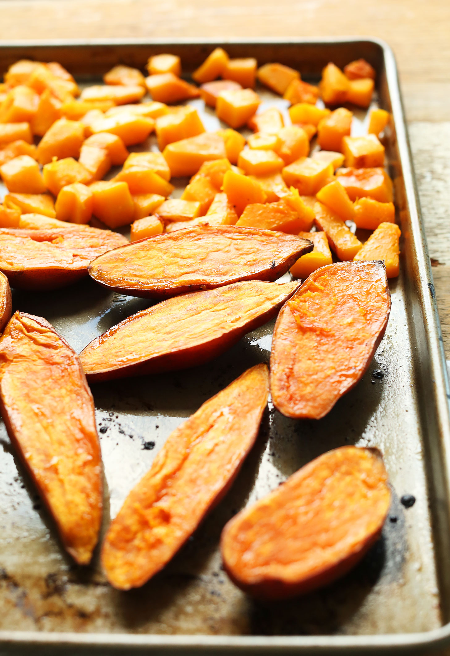 Baking sheet with sweet potatoes and butternut squash for roasting