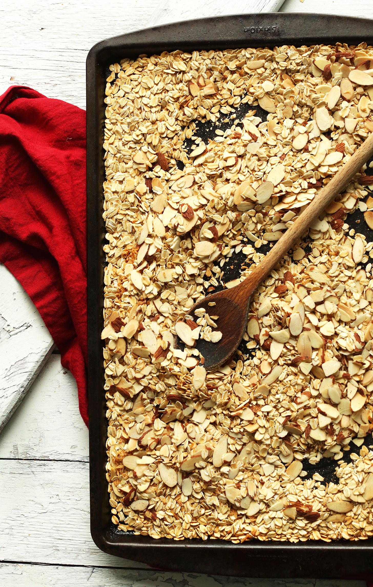 Baking sheet with oats and almonds for making our Easy homemade Peanut Butter Granola Bars