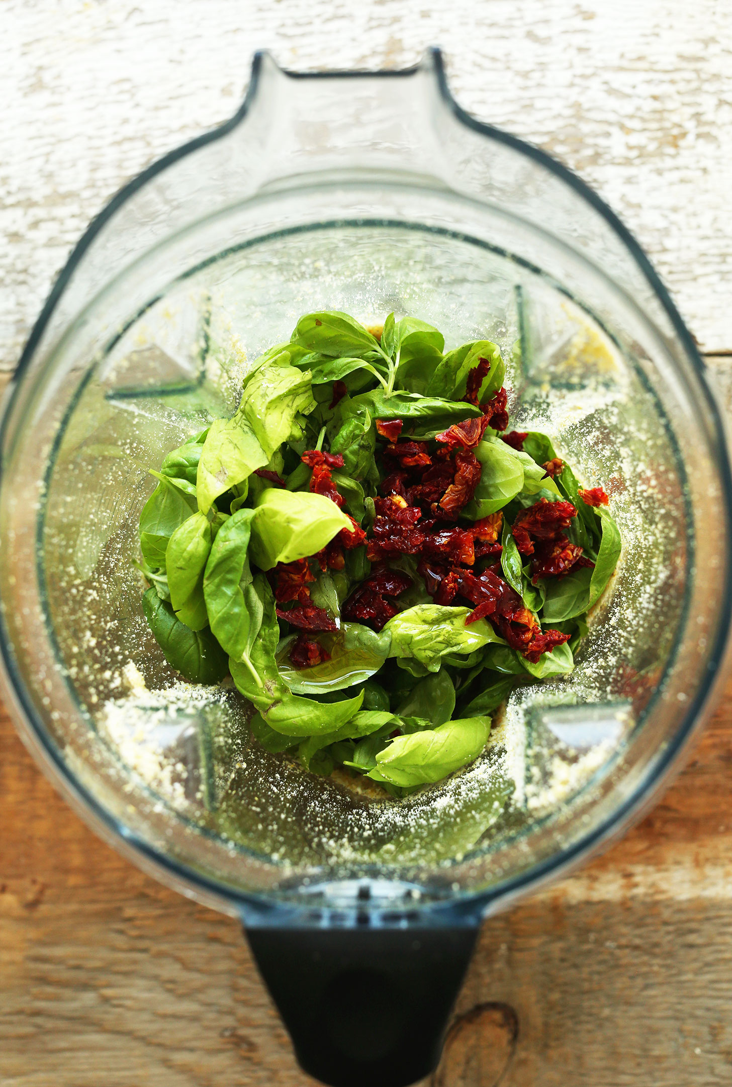 Blender with ingredients for making homemade Sun-Dried Tomato and Basil Vegan Pesto