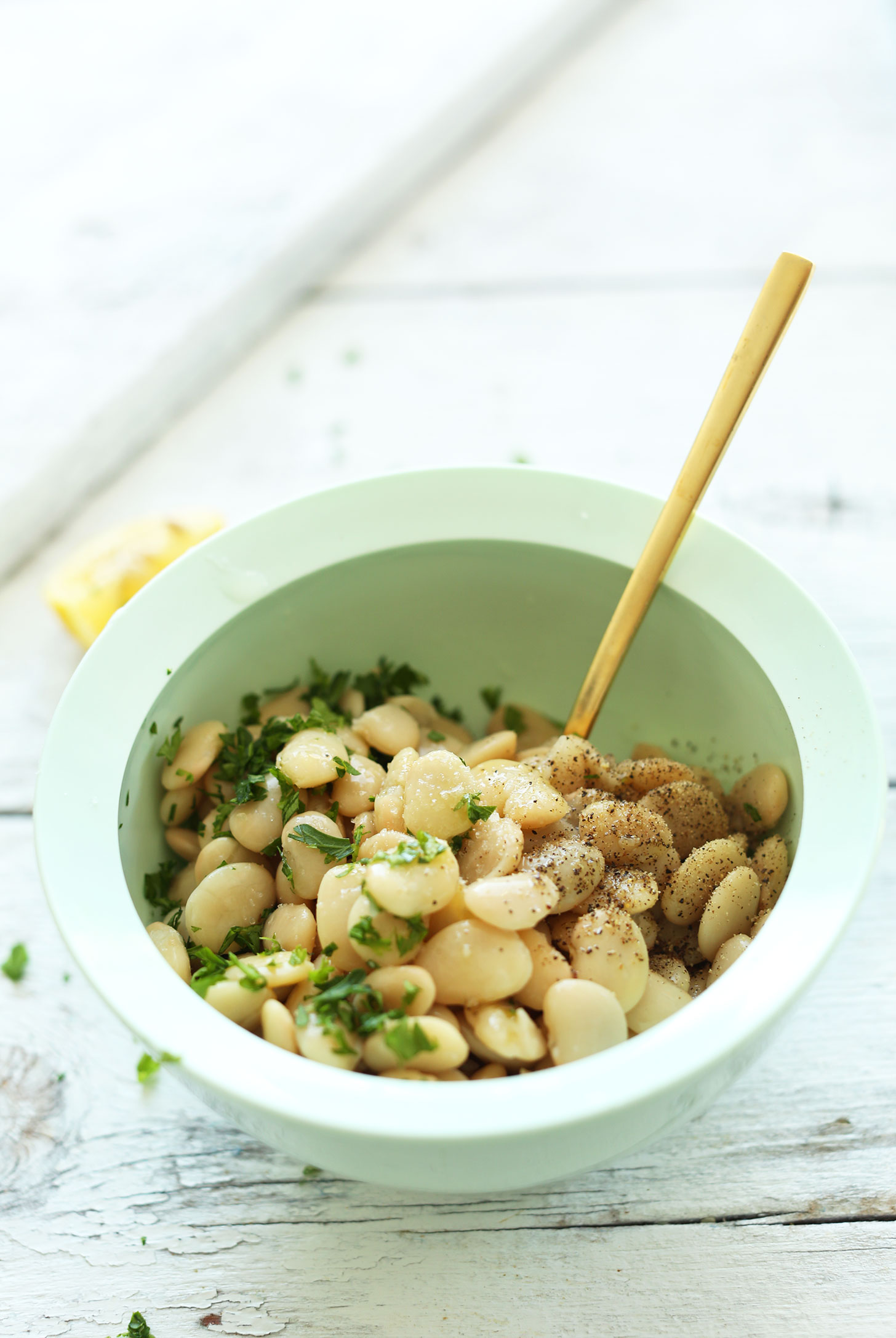 Bowl of butter beans and seasonings for making a super healthy vegan kale salad