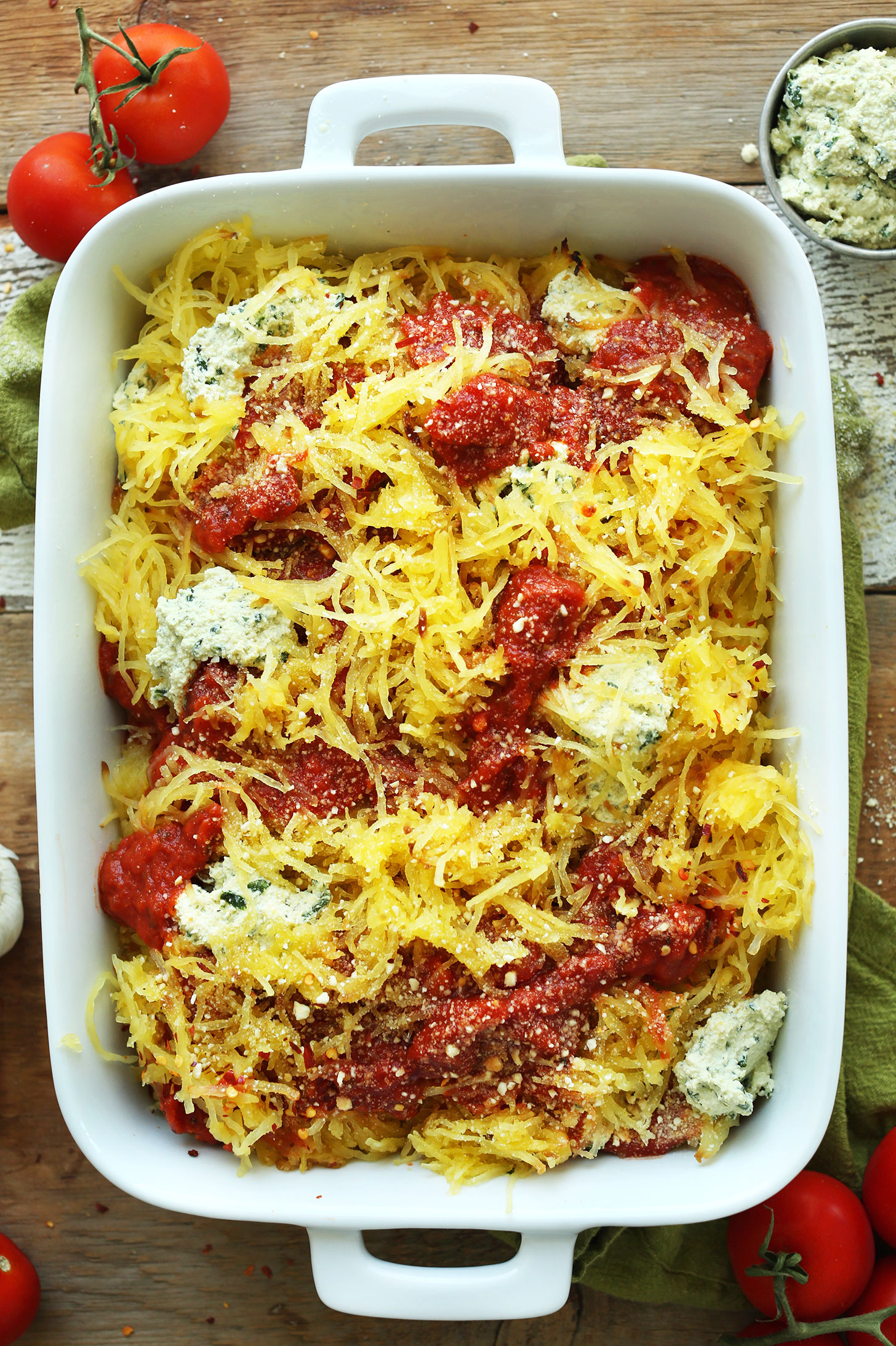 Ceramic baking dish with healthy Spaghetti Squash Lasagna Bake for a gluten-free vegan meal