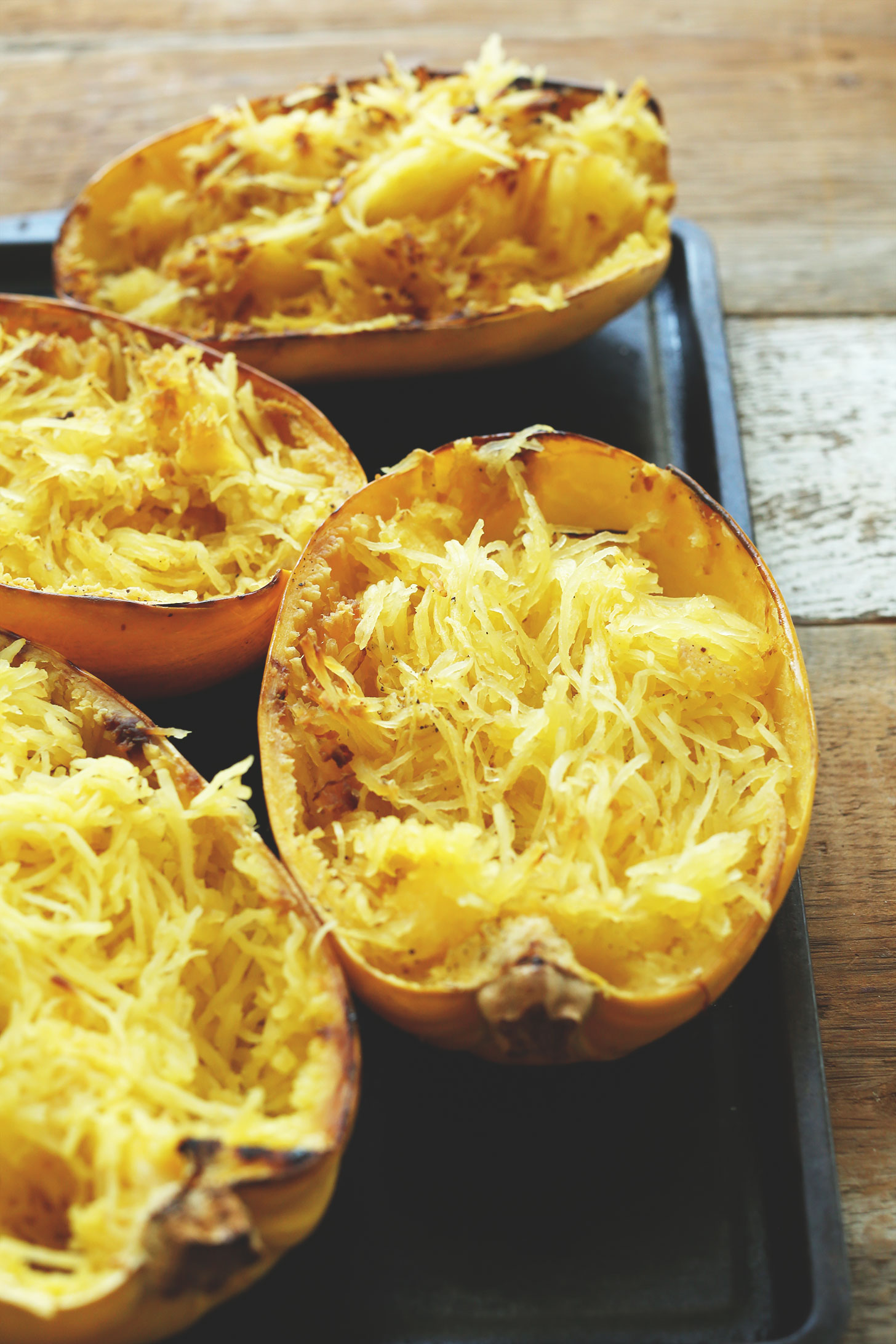 Baking sheet with spaghetti squash for the ultimate vegan fall spaghetti squash recipe