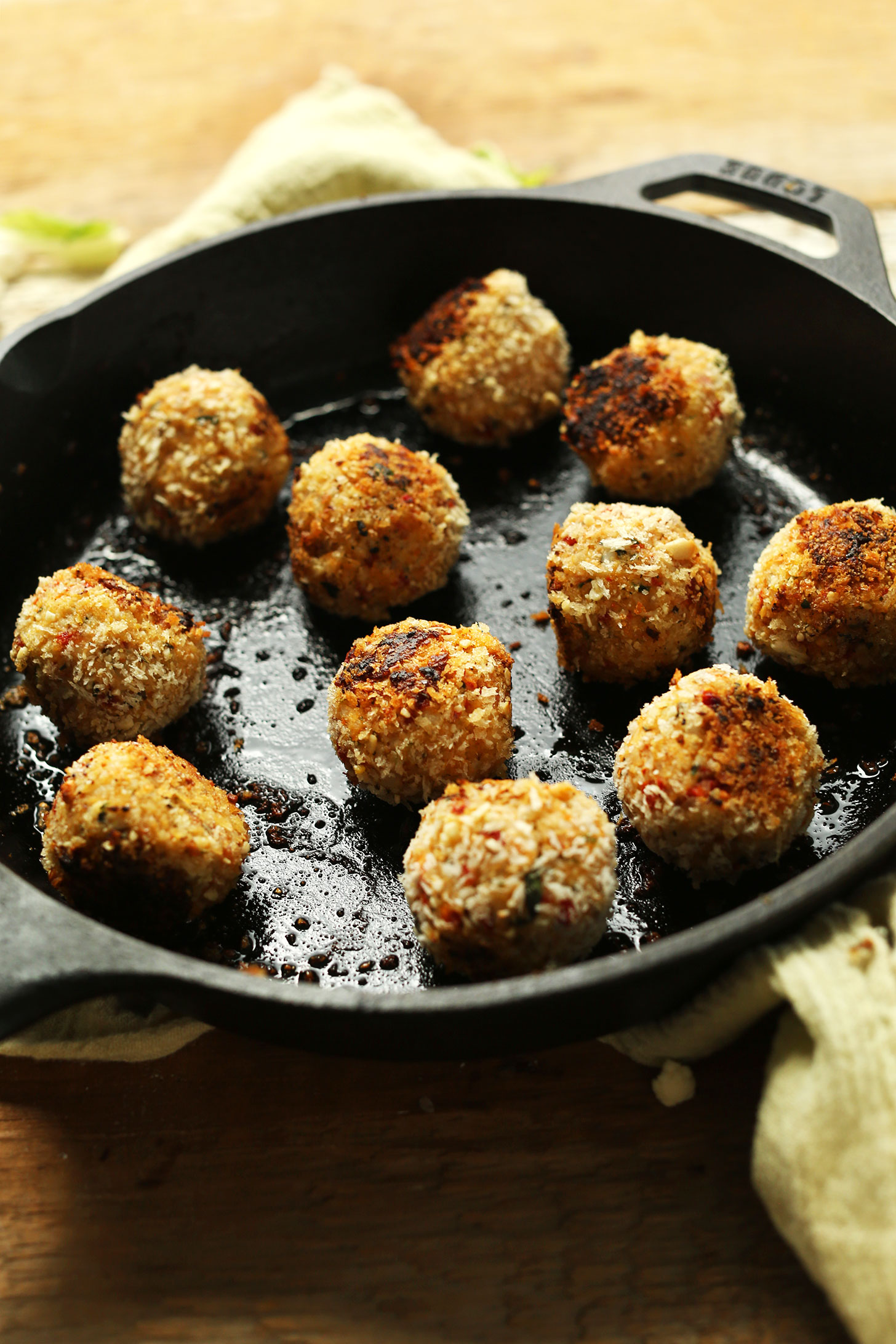 Cooking homemade Vegan Arancini in a cast-iron skillet