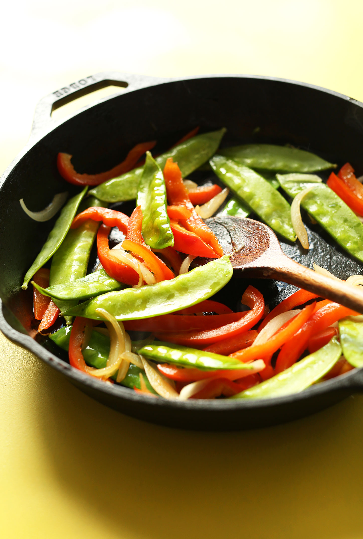 Sautéing vegetables in a cast-iron skillet for our Vegan Singapore Noodles recipe