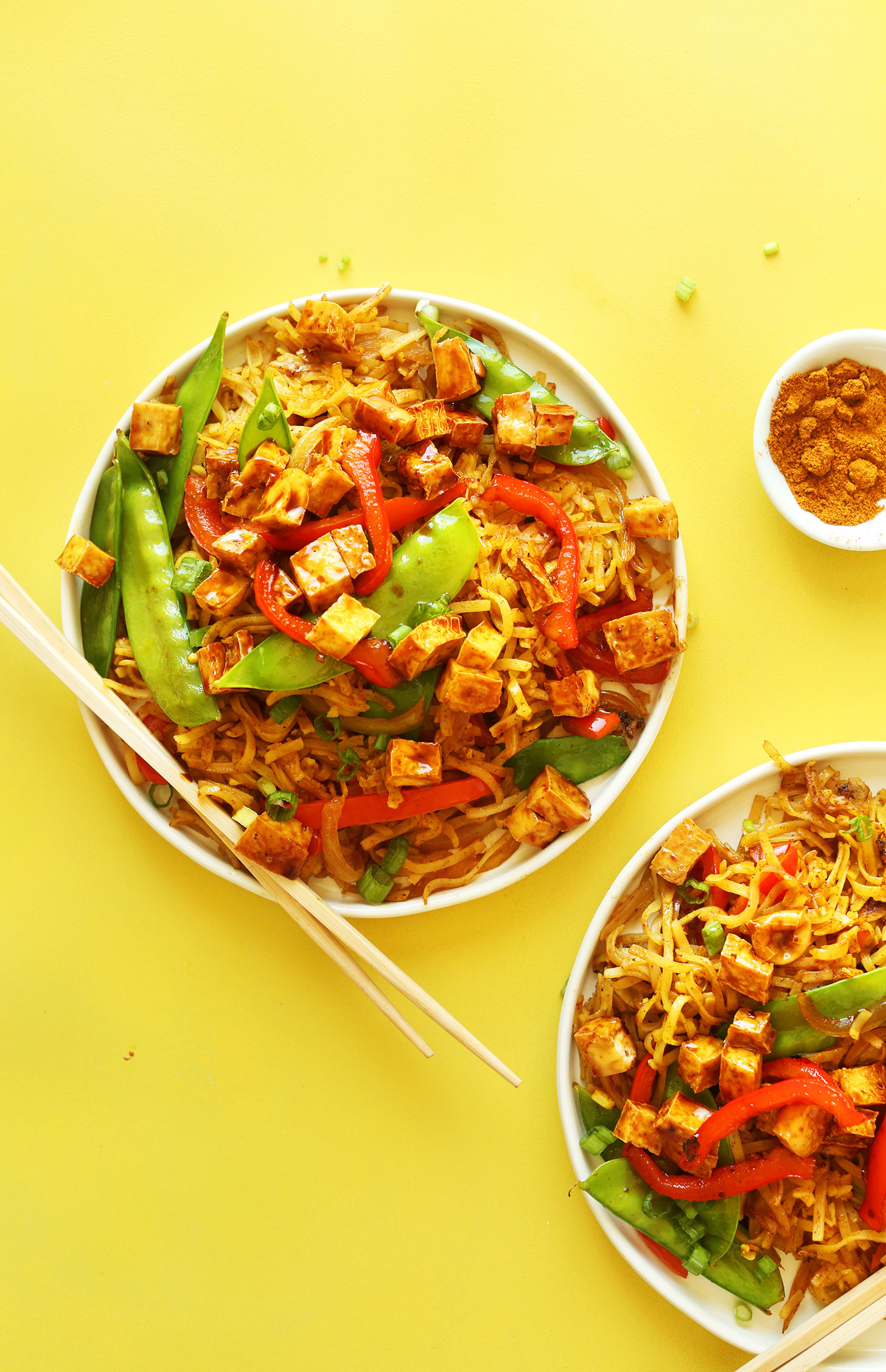 Dinner plates piled high with delicious Vegan Singapore Noodles for a flavorful simple meal