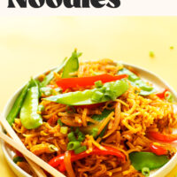 Chopsticks on a plate of vegan singapore noodles