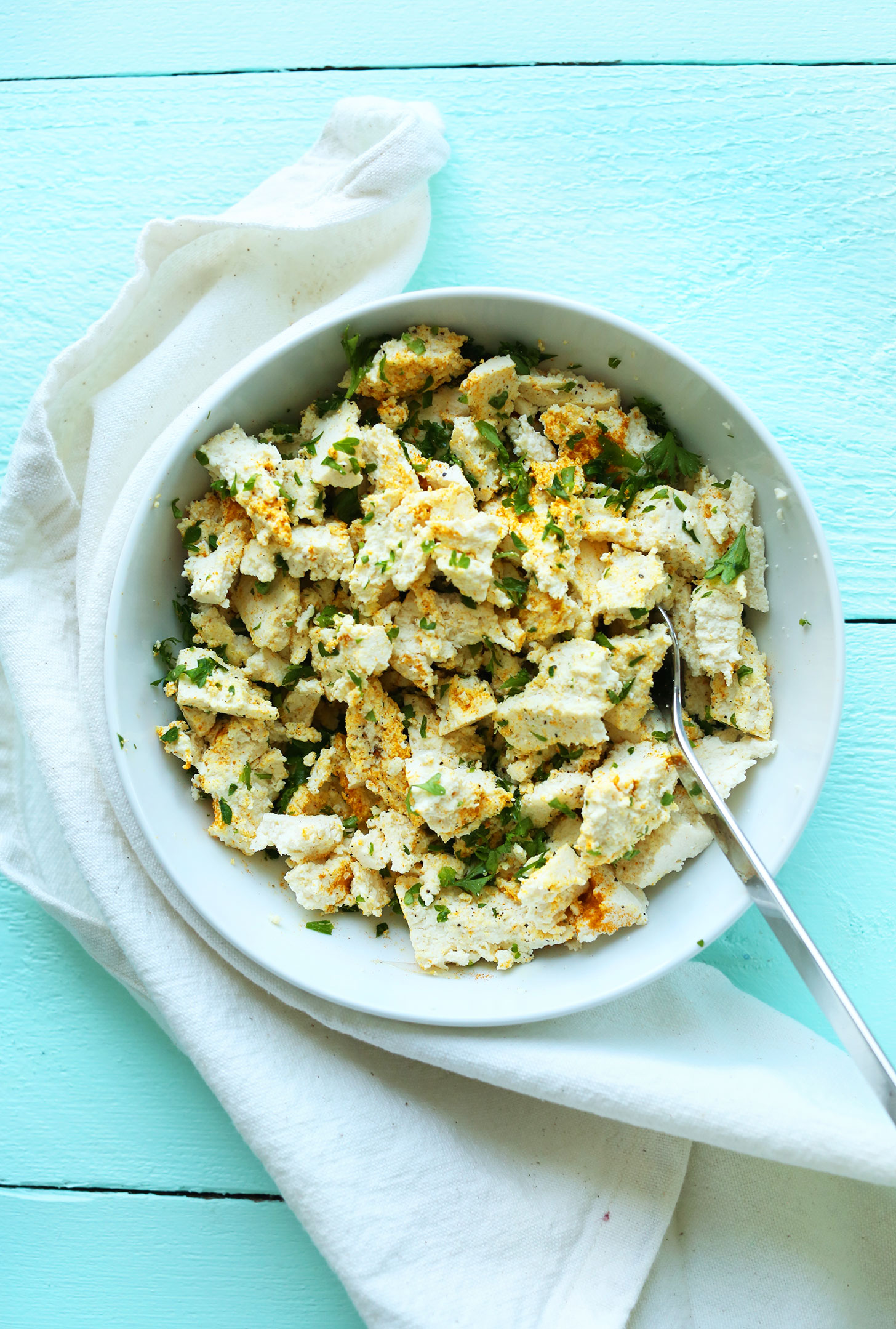 Bowl of tofu and herbs for making our Savory Tofu Breakfast Scramble recipe 