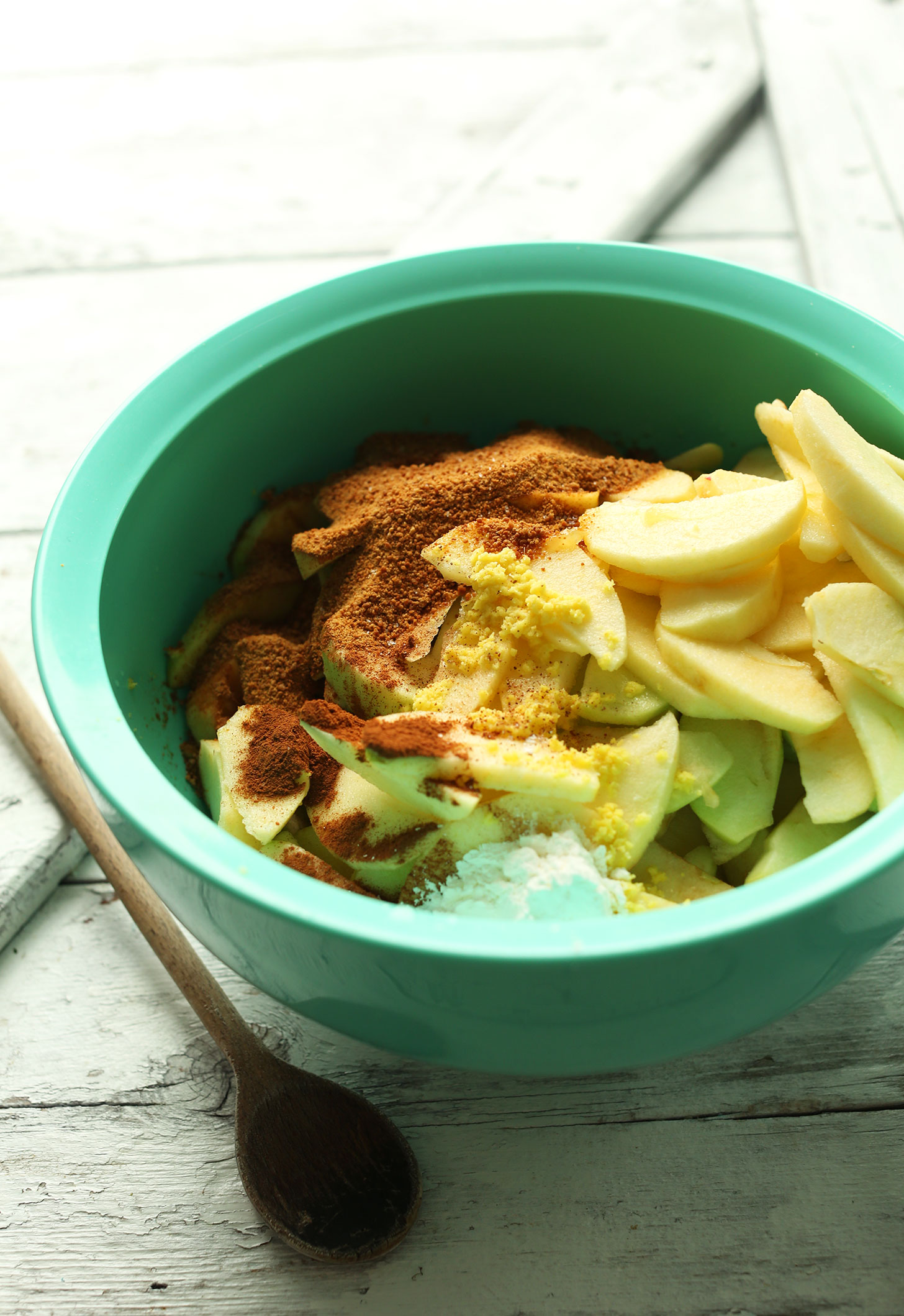 Mixing bowl with ingredients for making the filling for the Best Vegan Apple Crisp